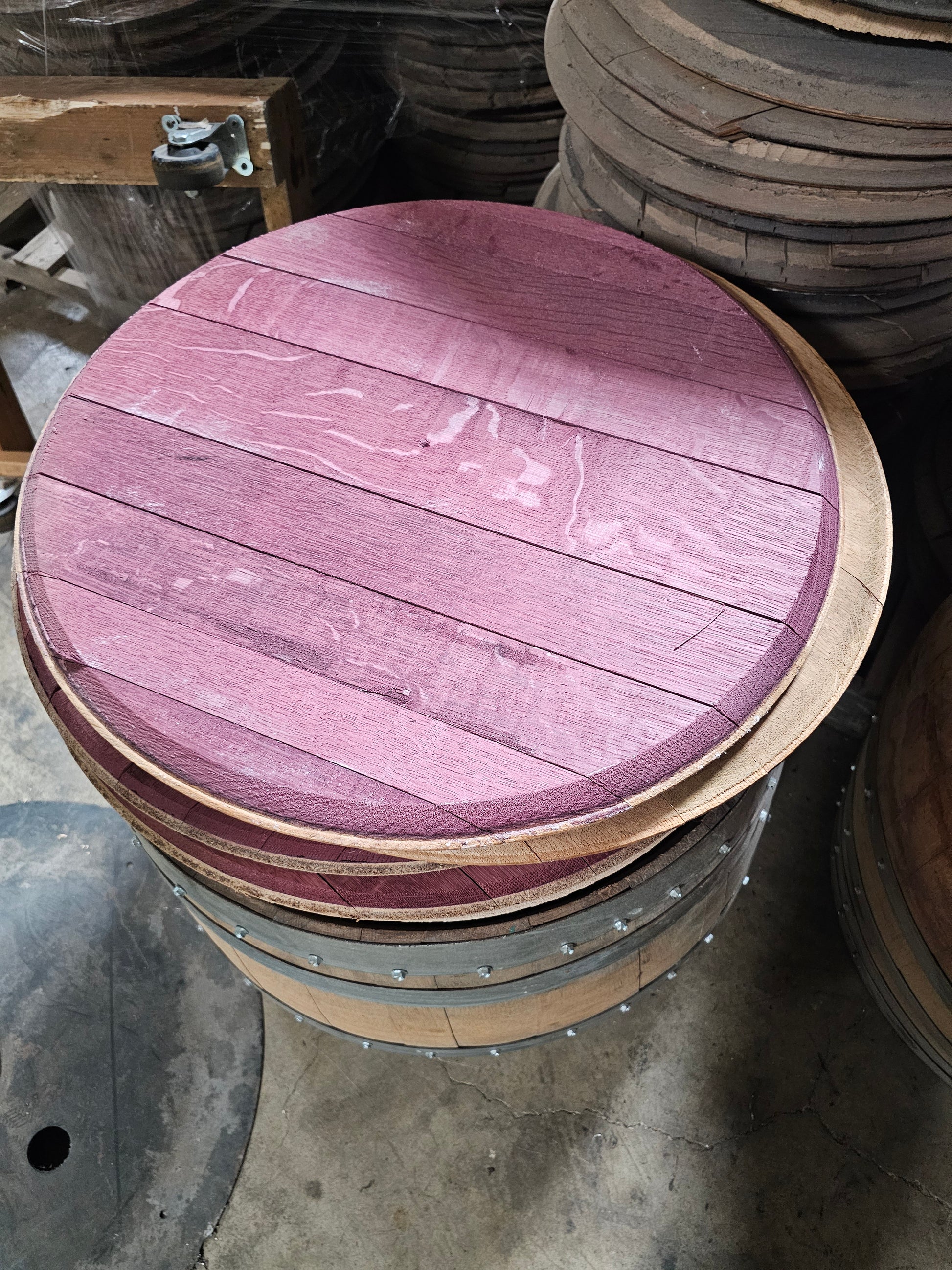 underside of red wine barrel head in a stack