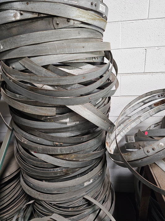 Stack of metal hoop against a tiled wall
