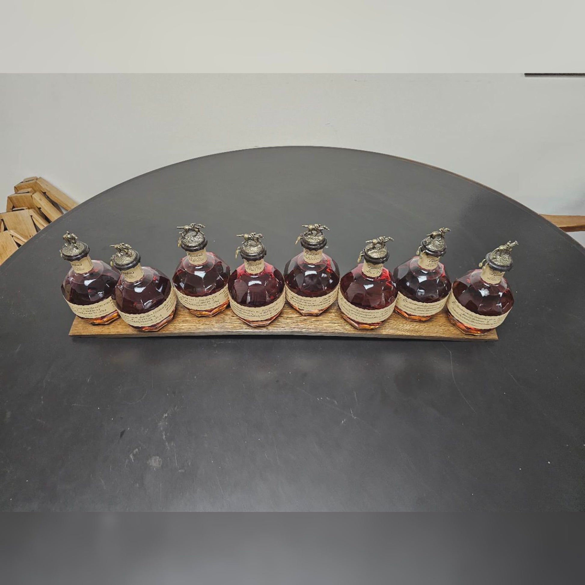 Actual handcrafted barrel stave holding eight collector bottles; bottles not included.