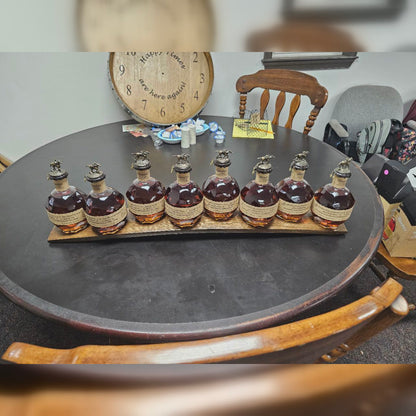 Angled view of eight bottles seated in the handcrafted barrel stave; bottles not included.