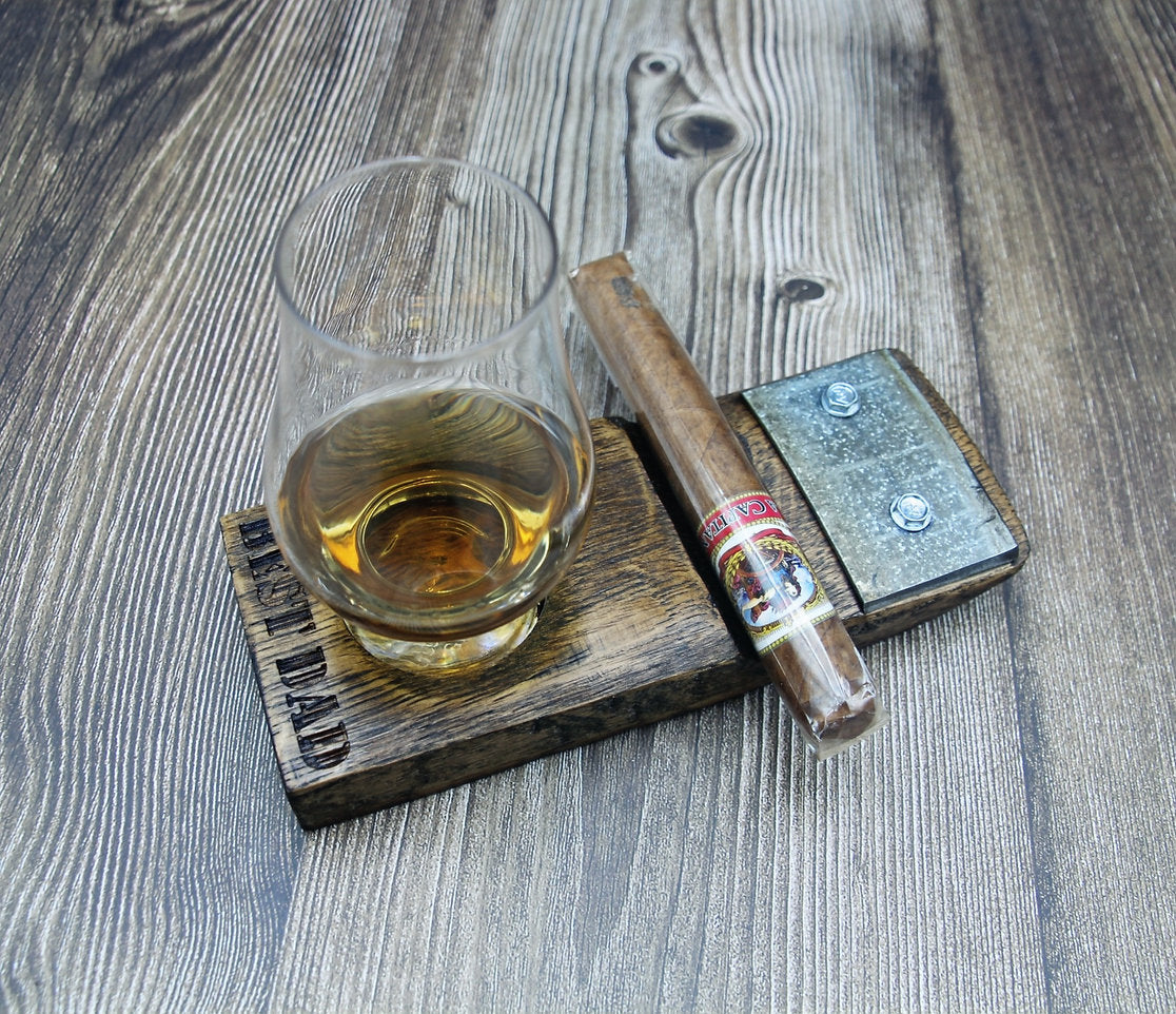 Personalized cigar coaster holding a Glencairn glass and cigar on a wood table