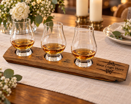 Three-glass whiskey flight with engraved handle at a candlelit dinner.