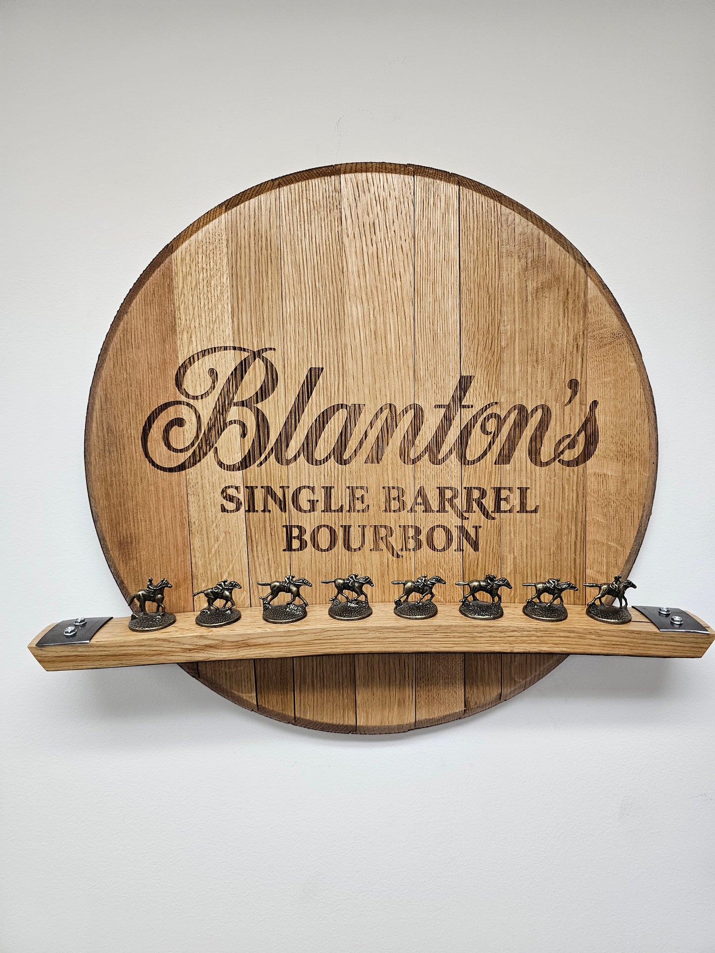 Detailed front view of the engraved oak barrel head and eight-position stave holder; stoppers are not included.