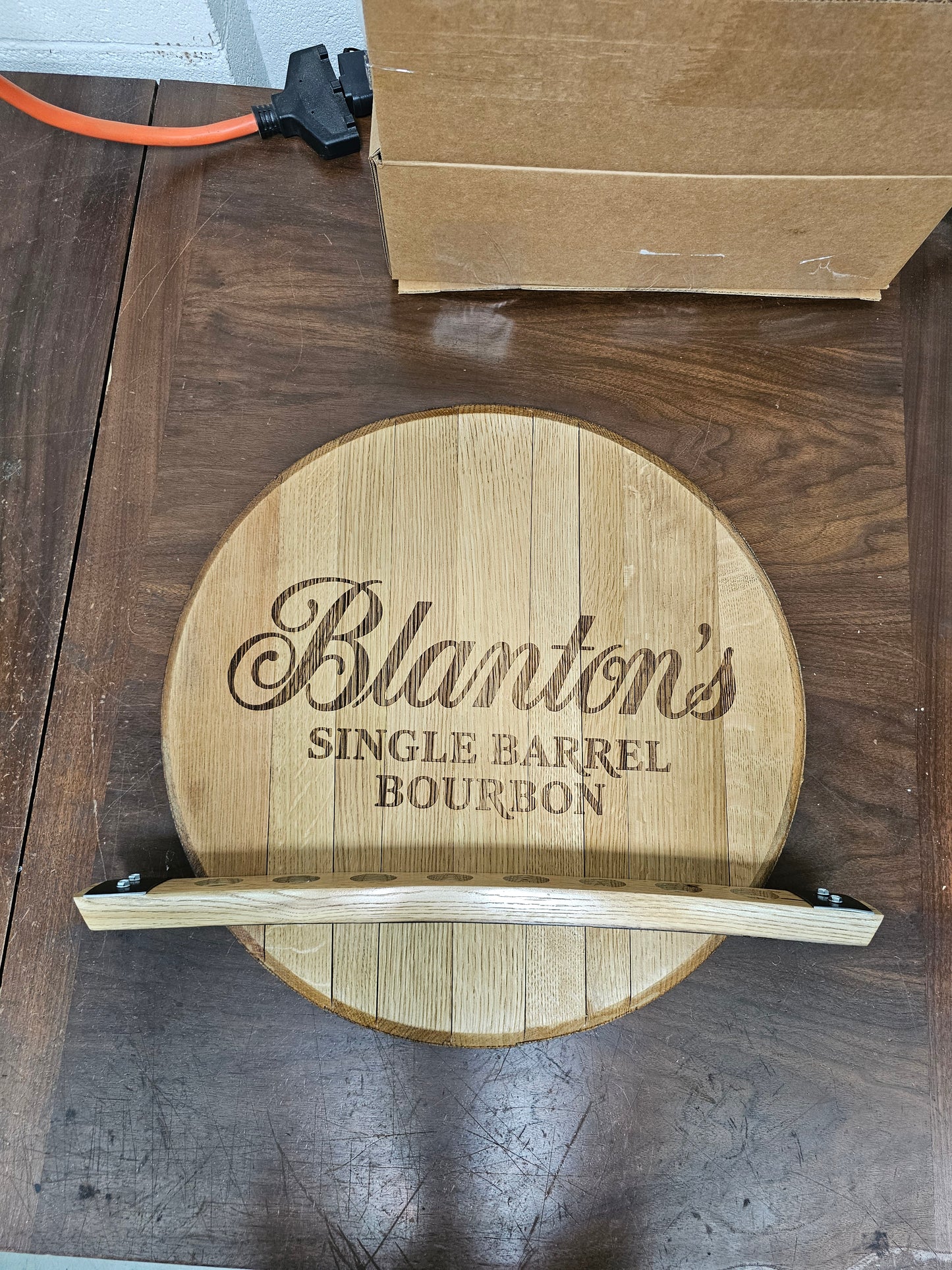 Close view of the empty reclaimed oak stave holder with eight routed openings.