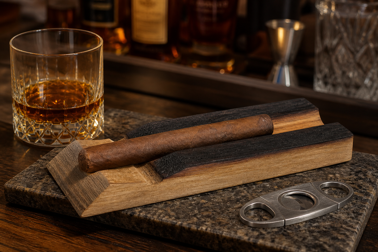 Handmade reclaimed bourbon barrel stave cigar holder with cigar on a home bar counter beside whiskey and a cigar cutter