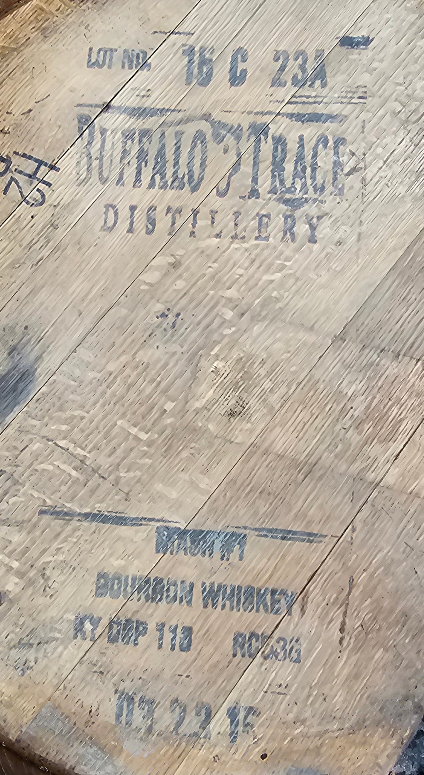 Close-up of a wooden barrel headwith "Buffalo Trace" branding.